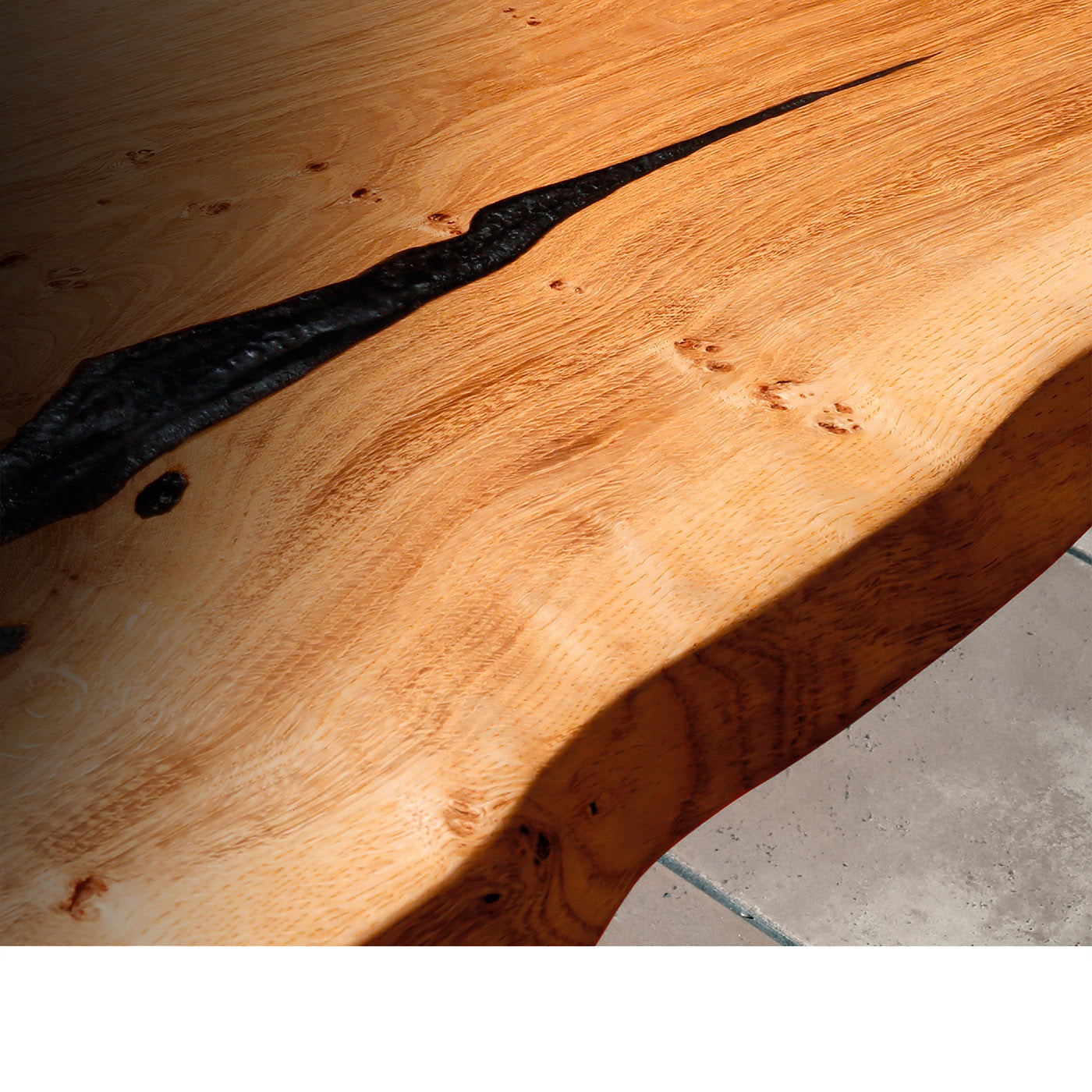 Close up of the beautiful grain on a resin filled live edge table. Showcasing the quality of the craftsmanship.