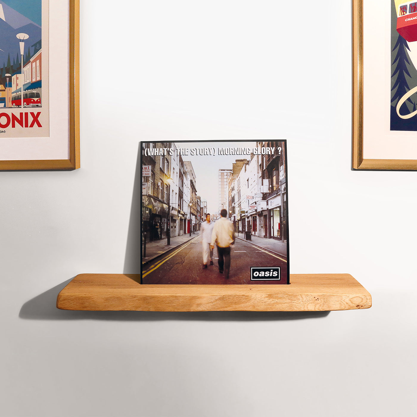 A wall mounted live edge oak shelf that has a pre-cut groove to house vinyl record sleeves.  Oasis what's the story morning glory is sat in the slot.